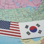 Alliance In Crisis — What Broke? United States and South Korea flags on a map of North America