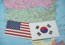 United States and South Korea flags on a map of North America