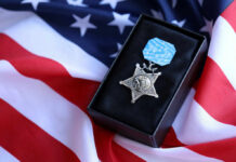 Ignored For Decades, Hero Finally Recognized Medal of Honor on American flag background
