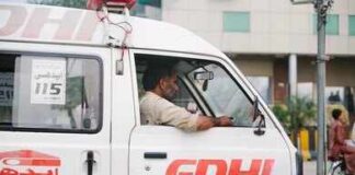 Ambulance driver in a white EDHI van
