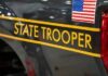 New York State Police cruiser side with emblem and yellow stripe