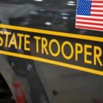 Routine Traffic Stop Ends In Tragedy New York State Police cruiser side with emblem and yellow stripe
