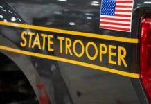 Routine Traffic Stop Ends In Tragedy New York State Police cruiser side with emblem and yellow stripe