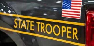 New York State Police cruiser side with emblem and yellow stripe