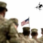 US Army Prepares For Drone Wars Soldier saluting from atop a tank with an Israeli flag in the background