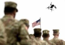 US Army Prepares For Drone Wars Soldier saluting from atop a tank with an Israeli flag in the background