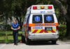 Medic walking near an ambulance in a park