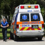 Pool Tragedy Leaves Family Devastated Medic walking near an ambulance in a park