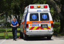 Pool Tragedy Leaves Family Devastated Medic walking near an ambulance in a park