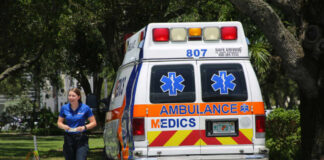 Medic walking near an ambulance in a park