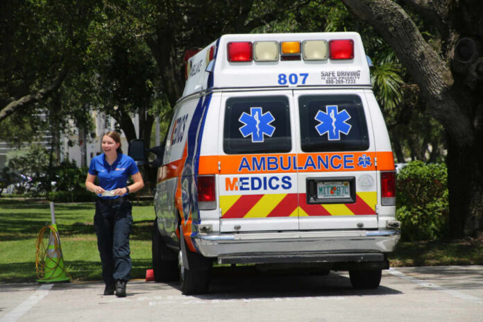 ambulance-parked1746468065jpg Medic walking near an ambulance in a park