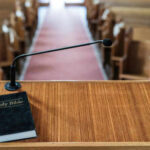 Another Blow Against The Church Bible and microphone on a church pulpit