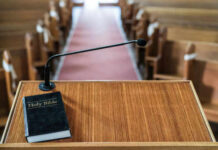 Another Blow Against The Church Bible and microphone on a church pulpit