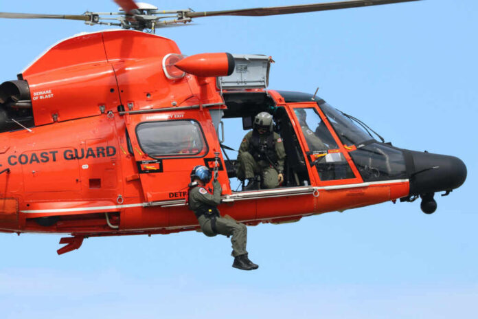 Rescue helicopter with crew performing hoist operation