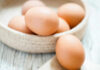 Brown eggs in a woven basket.