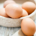 Egg Price Scandal Hits Grocery Bills Brown eggs in a woven basket.