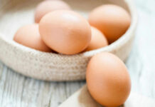 Brown eggs in a woven basket.