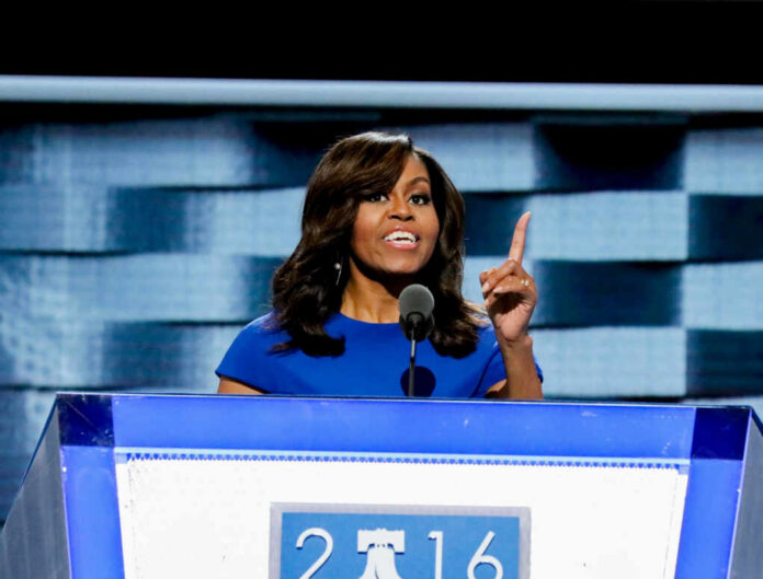 michelle-obama-delivers-her-speech1221256123jpg-1 I dont know who this is speaking at a podium