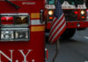 Construction Crisis Hits Former Pfizer Tower Fire trucks with American flag, New York City.