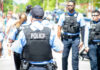 Meth Bust Snags Ex-Star Democrat Police officers in vests walking through a crowded street