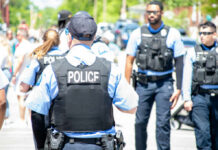 Meth Bust Snags Ex-Star Democrat Police officers in vests walking through a crowded street