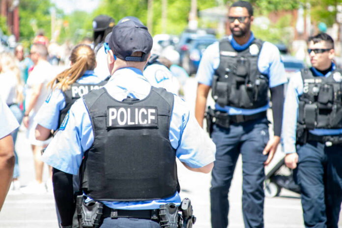 police-officer2162943397jpg Police officers in vests walking through a crowded street