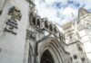 Police Continue Probe Into Former PM’s Murder Royal Courts of Justice exterior with Gothic arches