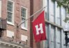 Red flag with large white H on building facade