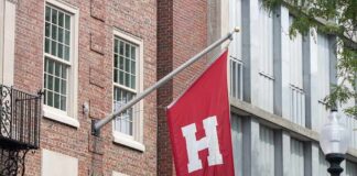 Red flag with large white H on building facade