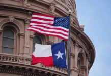 Texas Landslide Shreds ‘Racist Race’ Claim American and Texas flags flying in front of a government building