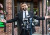 What Zohran Mamdani Actually Skipped Man in a suit speaking at outdoor press conference with multiple microphones