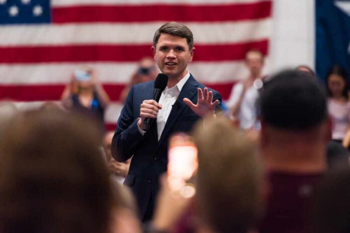 Austin,,Texas,United,States,-,July,25th,,2025,-,James Speaker in a suit addressing an audience with a microphone