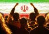 Declared Dead, Now Seen Publicly Crowd of people raising their fists in front of the Iranian flag