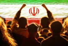 Declared Dead, Now Seen Publicly Crowd of people raising their fists in front of the Iranian flag