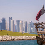 Doha Becomes Diplomatic Battleground Doha skyline with Qatar flag and dhow boat