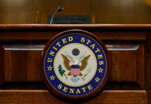 GOP Civil War Explodes Over Filibuster United States Senate emblem on wooden podium