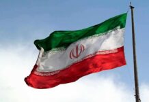 Iran Faces A New Sanctions Barrage Iranian flag waving on a pole