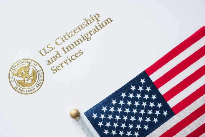 shutterstock_1149862052 U.S. Citizenship and Immigration Services document with American flag