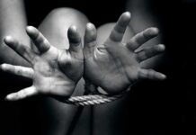 Chilling Predator Network Hides In Plain Sight Hands bound with rope in black and white