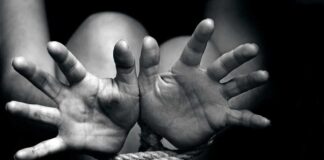 Hands bound with rope in black and white