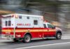 Ambulance speeding down a city street with lights flashing
