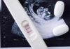 Pregnancy test with two lines on an ultrasound print