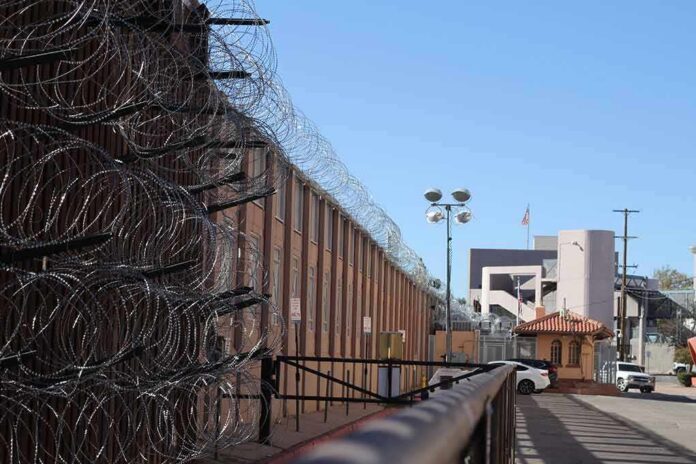 shutterstock_1630378858 Razor wire along a prison perimeter fence