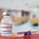 vaccine vial and syringe on a counter in a clinic