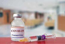 vaccine vial and syringe on a counter in a clinic