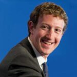 smiling man in a suit looking to the side