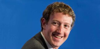 smiling man in a suit looking to the side