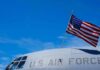 Air Force One Leak Sparks Unprecedented Punishment American flag on U.S. Air Force aircraft against blue sky