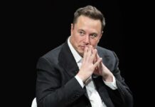 man in a suit with hands clasped thoughtfully
