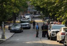 Welfare Check Turns Deadly Police officers secure a residential street with patrol cars and yellow tape